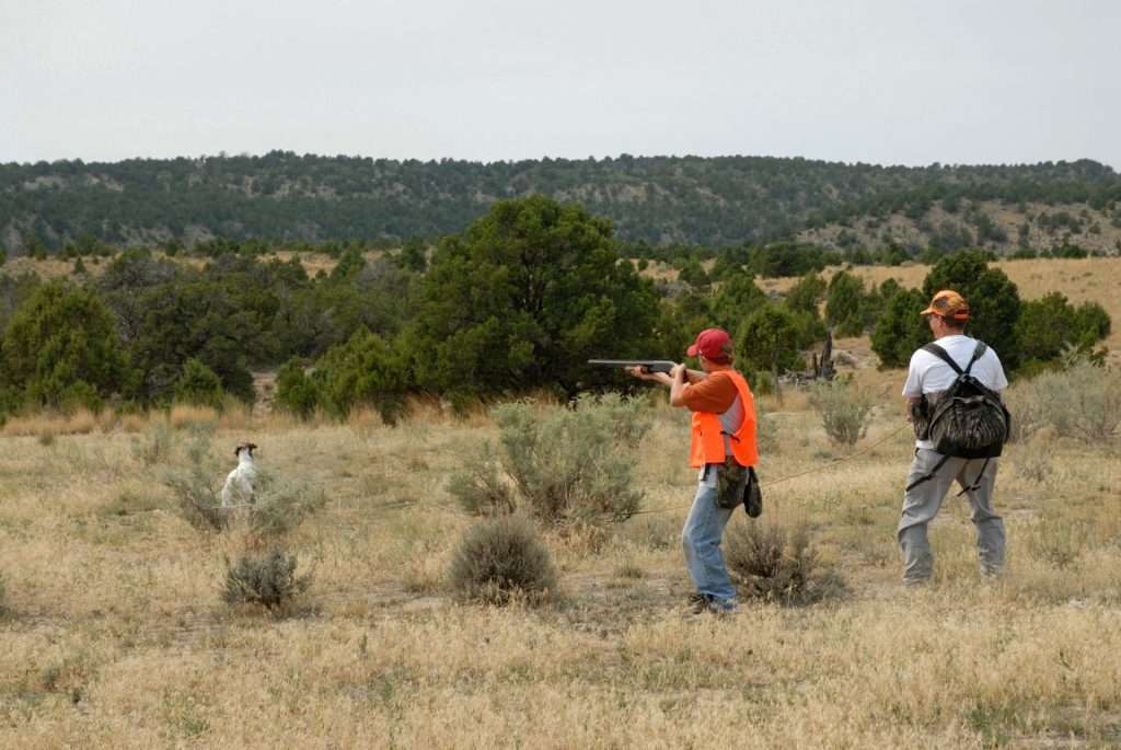 brent 9 8 2007 young hunter aims at chukar with dad and dog